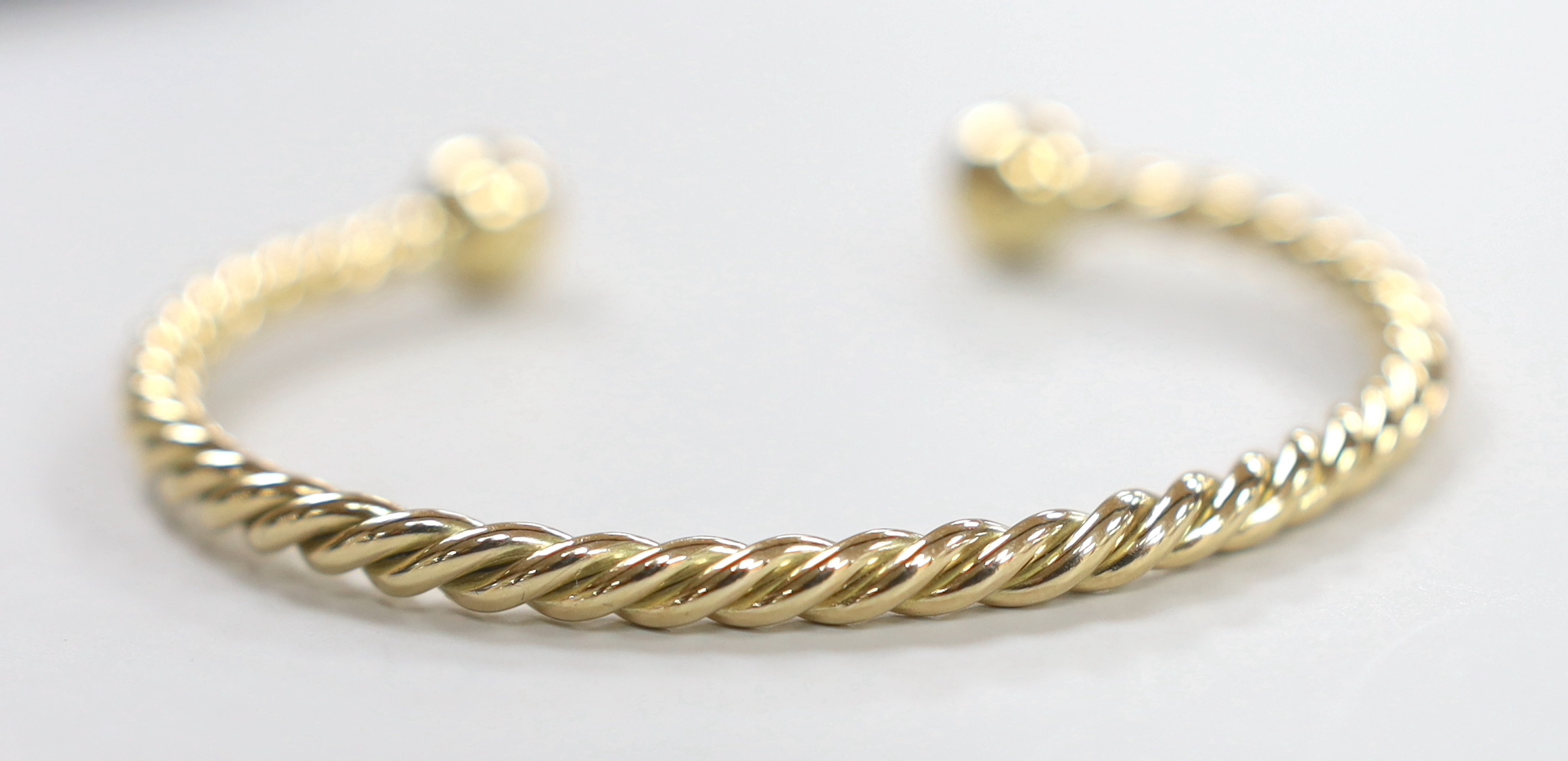 A modern 9ct gold rope twist bangle, 22.1 grams.